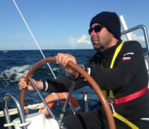 a sailor with a steering wheel on the Atlantic Ocean